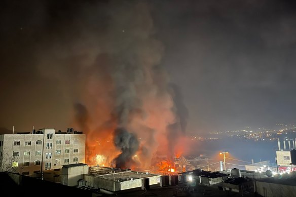 Smoke and flames rise after Israeli settlers went on a rampage in the West Bank town of Huwara, setting fire to several homes.