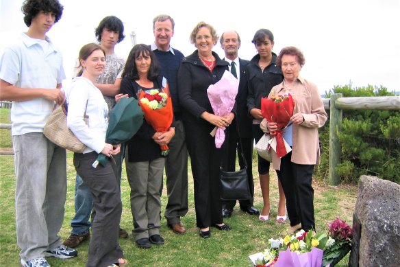 Rita Drakopoulos with her son and daughter David and Denise, cousins Denis and Helen Kelly and grandchildren, prepare to place flowers on the Rip memorial at Shortlands Bluff in Queenscliff.