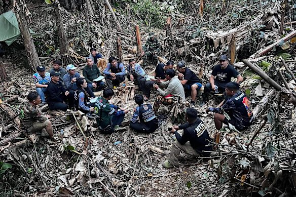 Rescuers gather, trying to reach people who have been trapped in a cave in Xaisomboun province, Laos.