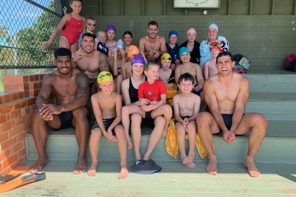 Melbourne Storm players last month visited areas devastated by bushfire near Bega, and took part in Cobargo's swimming carnival. 