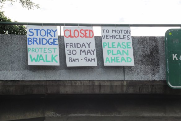 Signs went up on the Story Bridge warning of the protest on Friday.