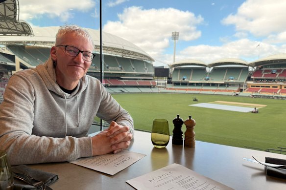 Historian Tom Holland enjoys a view of Adelaide Oval over breakfast.