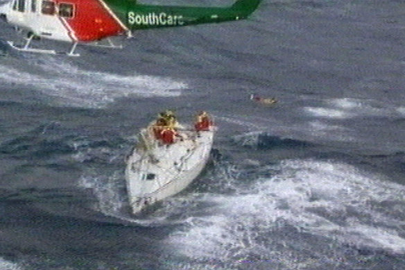 A rescue helicopter hovers over a yacht battered by gale-force winds in the 1998 Sydney-to-Hobart race.