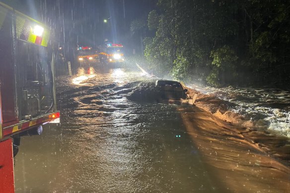 NSW Rural Fire Service firefighters and police rescued a person trapped on the roof of their vehicle in fast flowing flood waters.