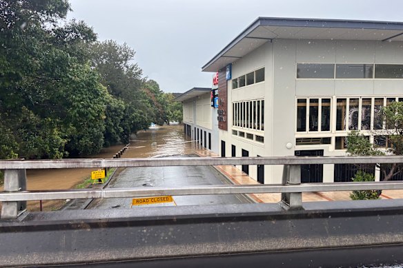 A road and shopping centre flooded in Kempsey.