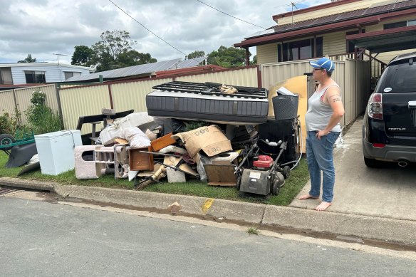 Cassie Whitfield-De Graaff’s wife Anique assesses their belongings damaged by flash flooding in Moreton Bay.