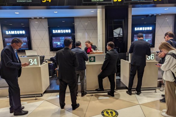 Qantas passengers checking in for their recovery flight from Baku to London.