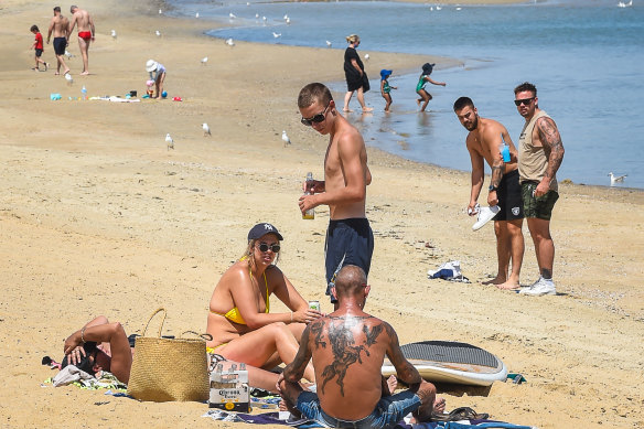 People relax at St Kilda beach during COVID-19 lockdown on Tuesday.