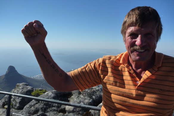 Jesper Jensen on top of Tabletop Mountain in South Africa, showing off a tattoo he dedicated to his late wife Gerri. He was due to go on the trip with her, but she died before they could go - he went with daughter Belinda instead.