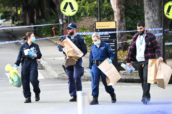 Forensic officers gather evidence at the university.