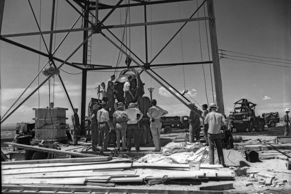 Workers mounting the world’s first atomic device, dubbed “the Gadget”, to a test tower at the Alamogordo Bombing Range in New Mexico in July 1945.