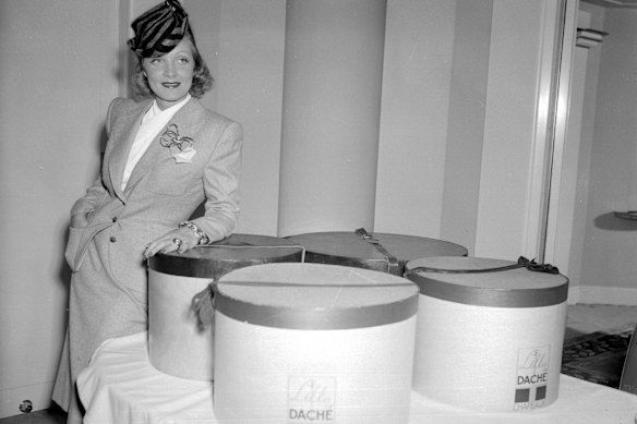Marlene Dietrich, with hat boxes, arriving in New York aboard the ship.