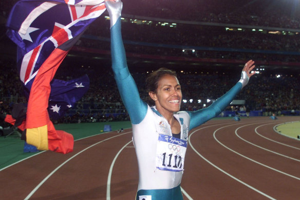 Cathy Freeman carries the Aboriginal and Australian flags on a victory lap after winning the 400 metres at the 2000 Olympic Games in Sydney.