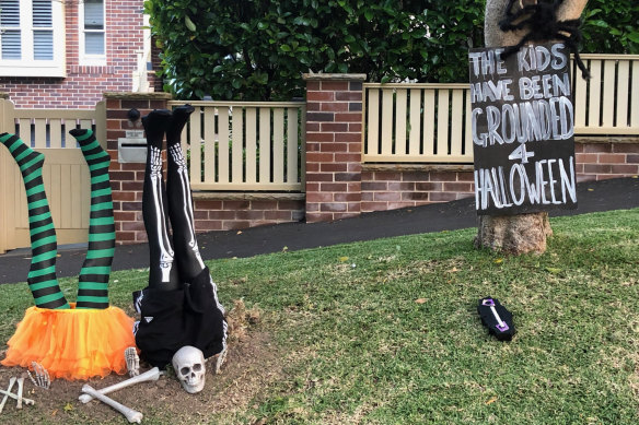 Halloween decorations by the Powell family of Roseville. The sign reads: "The kids have been grounded this Halloween. 