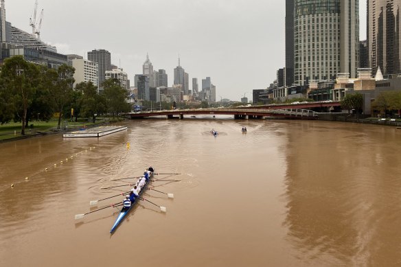 The Yarra River turns a deeper shade of orange-brown after dusty rain fell over Melbourne.