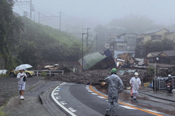 In this photo taken by Satoru Watanabe, a road is covered by mud and debris  after a mudslide following heavy rain in Atami, Japan, on Saturday. 