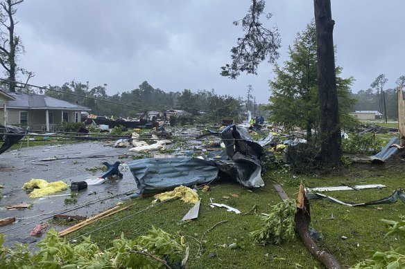 Debris covers a street in East Brewton, Alabama following a suspected tornado spurred by Tropical Storm Claudette.