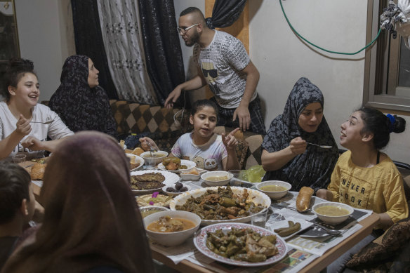 The Rajabi family shares an Iftar meal, breaking the day’s Ramadan fast, on May 9.