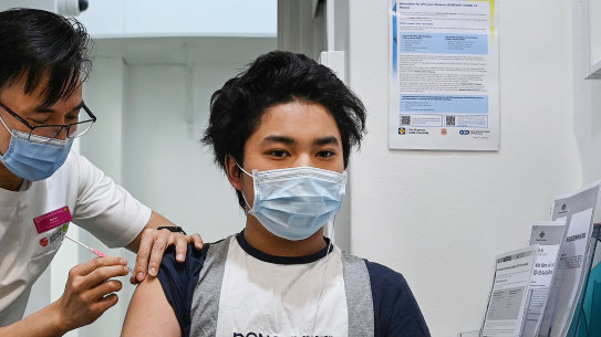 Pharmacist Quinn On administers his first Moderna vaccine to Dylan Nguyen Ton, aged 14, on Monday afternoon.