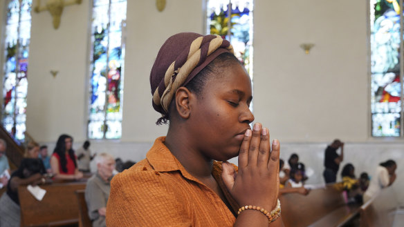 Marie Morette, a congregant of St Raphael Catholic church, prays during Mass in Springfield.