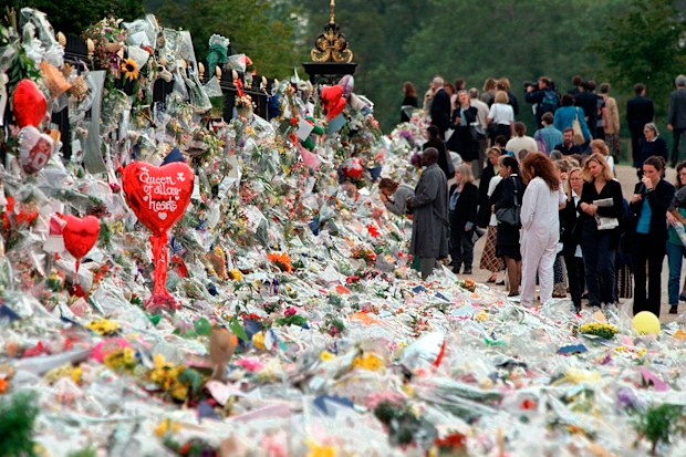 Mourners file past the tributes left in memory of Diana Princess of Wales at Kensington Palace in London, Friday, September 5, 1997.  