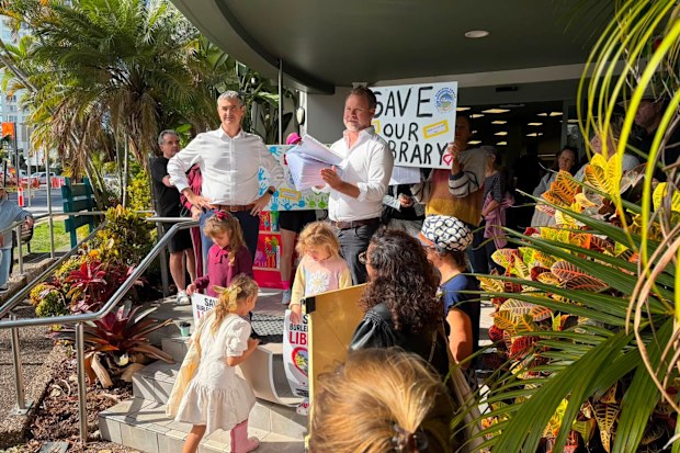Burleigh Heads MP Hermann Vorster and local councillor Josh Martin address locals outside Burleigh Heads library this morning.