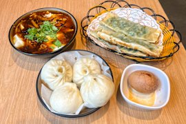 Clockwise from top left: Douhua tofu pudding, chive dumplings, tea egg, and pork and spring onion steamed buns.