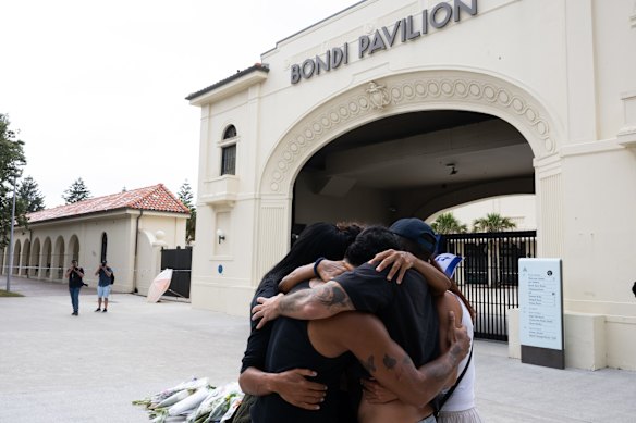 Flowers being lay flowers outside Bondi Pavillion.