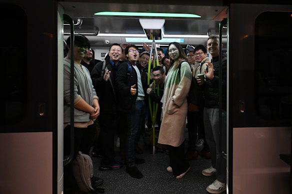 Crowds board the first Metro train at Sydenham station on the M1 line.