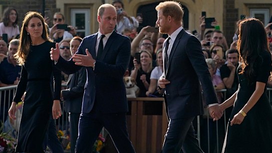 Prince William and Kate, Princess of Wales, and Prince Harry and Meghan, Duchess of Sussex walk to greet the crowds after viewing the floral tributes for the late Queen Elizabeth II outside Windsor Castle.