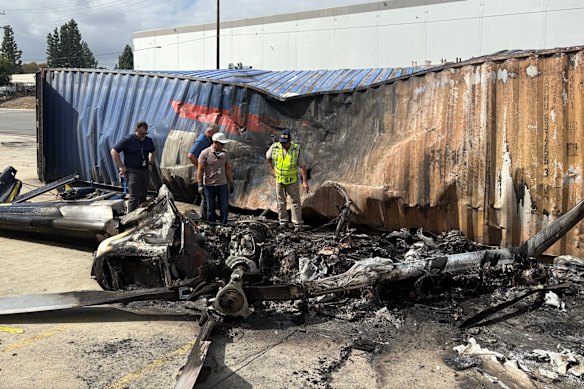 This image released by the National Transportation Safety Board shows NTSB investigator-in-charge Fabian Salazar, center, examining the scene Wednesday, Sept. 16, 2026, in Chatsworth, a neighborhood in Los Angeles, after a TV news helicopter crashed, killing multiple people on Tuesday, Sept. 15.