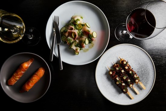 Salmon gravlax, ginger kingfish sashimi and pork belly skewers at Coda.