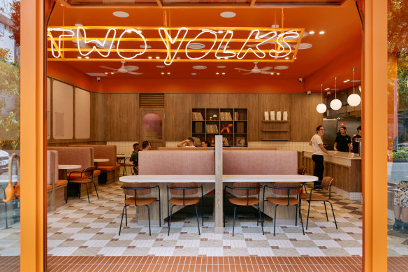 Two yolks features neon signage, diner-style booths, fluted glass and Japanese mosaic tile floors.