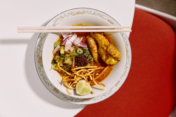 Khao soi egg noodle soup topped with braised chicken.