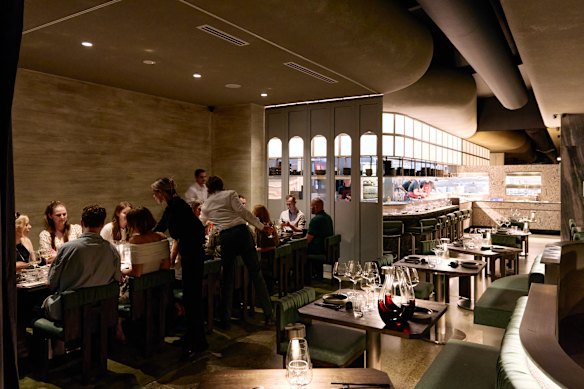 The restaurant is sectioned off into a series of smaller areas through a clever use of booths, different levels, curved ceilings and curtains. 