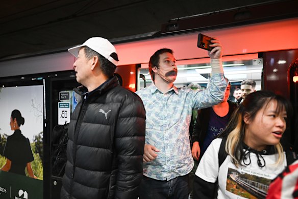 Crowds from the first Metro train exit at Chatswood station.