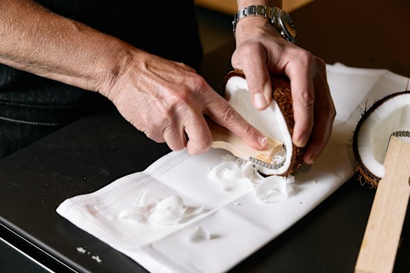 Boetz demonstrating how to use his coconut scraper.