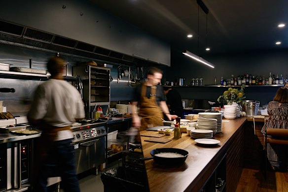 Most of the space is laid out with an open kitchen with low counters.