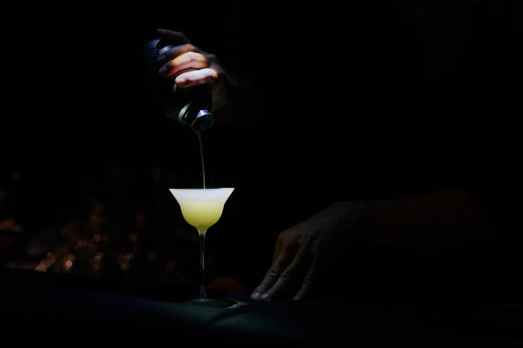 A White Tea Century cocktail being poured at Aizome.