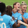 Charlize Rule celebrates with teammates after scoring against Wellington. 