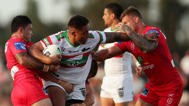 Junior Tatola of the Rabbitohs is tackled during the Charity Shield match at Glen Willow Sporting Complex.