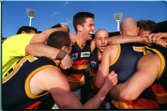 Crows players celebrate the preliminary final win.