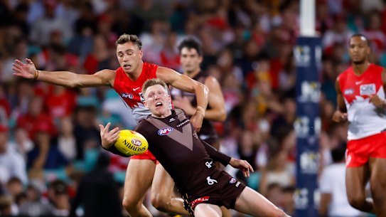 Will Hayward of the Swans and James Sicily of the Hawks compete for the ball.