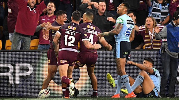 Game breaker: Queensland celebrate Dane Gagai's 95m intercept try that turned the game on its head.