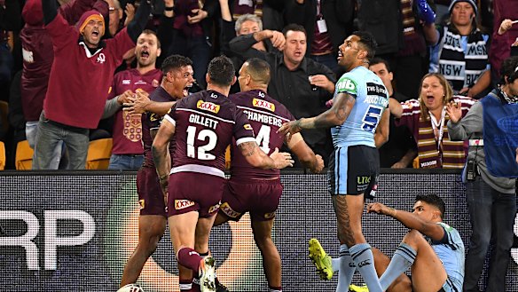 Game breaker: Queensland celebrate Dane Gagai's 95m intercept try that turned the game on its head.