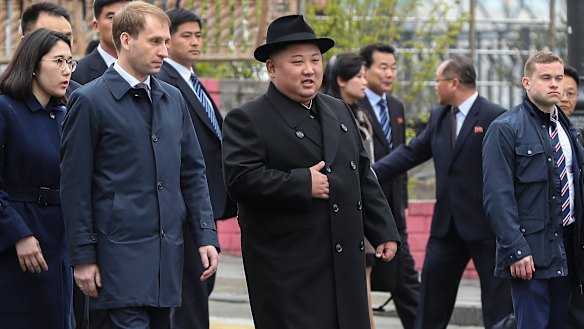 North Korean leader Kim Jong-un, centre, is surrounded by Russian and North Korean officials on arrival in Vladivostok, Russia.