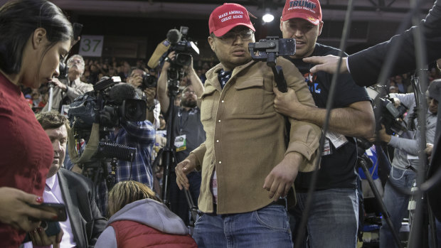 A Trump supporter (centre) is restrained after he storms the media area where journalists including BBC reporter Gary O’Donoghue (second from left) were working.