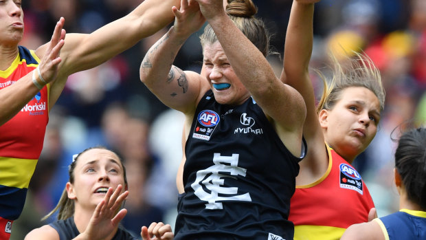 Erin Phillips of the Adelaide Crows and Brianna Davey of the Blues contest the ball  during the AFLW Grand Final match. 
