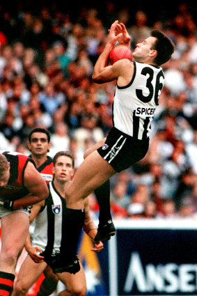 Saverio Rocca soars over Essendon’s Ryan O’Connor to take one of his big grabs.