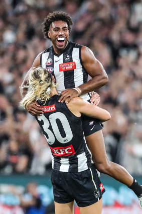 Quaynor celebrates with Magpies captain Darcy Moore.